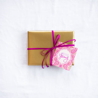 Intrinsic Forever Young Gift Tag with blank inside. Unique colourful birthday gift label with gold foil and inspirational quote on cover by Adele Basheer. Beautiful, hand-illustrated swing tag for birthday celebrations of any age, personalised gifts for someone’s special day and gift packs for birthday milestones.