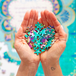 Handful of adult jigsaw puzzle pieces for personal growth and mindfulness at home