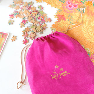 Intrinsic pink pouch to hold puzzle pieces for games night and family activities