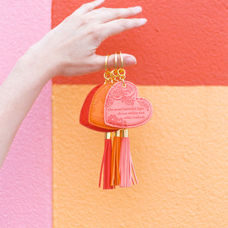 Bright coloured scarlet red key holder with vegan leather floral pattern and ruby red tassel. Featuring heartfelt quote by Adèle Basheer.