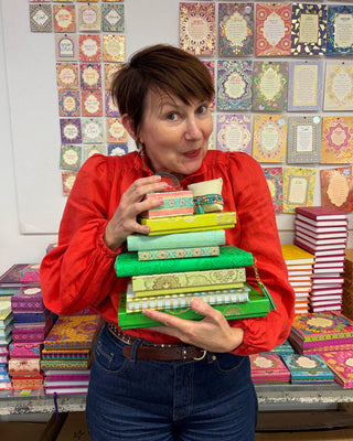 Adèle Basheer with a Green Lovers Mystery Bundle from the Intrinsic Archive Sale, featuring vintage gems, display samples, and end-of-line pieces from past journals, stationery, travel, ceramic, jewellery, accessories or homewares collections.