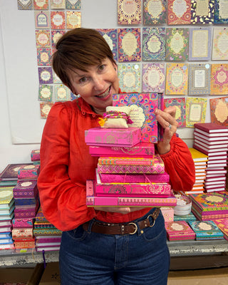 Adèle Basheer with a Pink Lovers Mystery Bundle from the Intrinsic Archive Sale, featuring vintage gems, display samples, and end-of-line pieces from past journals, stationery, travel, ceramic, jewellery, accessories or homewares collections.