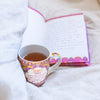 Perfect for your next journaling session, Intrinsic Inspirational Happy Vibes coffee and tea mug with hand drawn illustrations and motivational message by Adele Basheer.