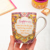 Intrinsic Happiness ceramic coffee mug with motivational message and pink and yellow illustrations 