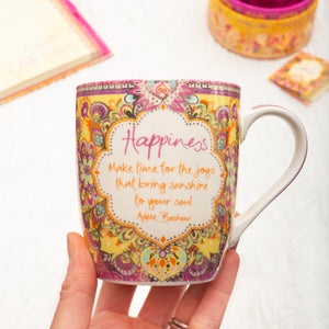 Intrinsic Happiness ceramic coffee mug with motivational message and pink and yellow illustrations 