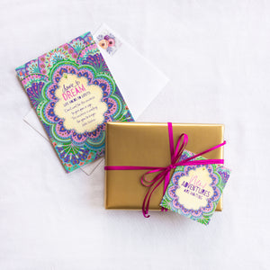 Intrinsic New Adventures are Waiting Gift Tag with blank inside. Unique colourful gift label with gold foil and inspirational quote on cover by Adele Basheer. Heartfelt swing tag to embrace new beginnings and trust in your own power.