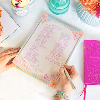 Intrinsic Guest List on writing pad