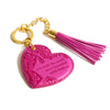 Inspirational vegan leather heart shaped magenta pink keychain with gold chain and bright pink tassel. Designed in South Australia. Motivational quote by Adèle Basheer.