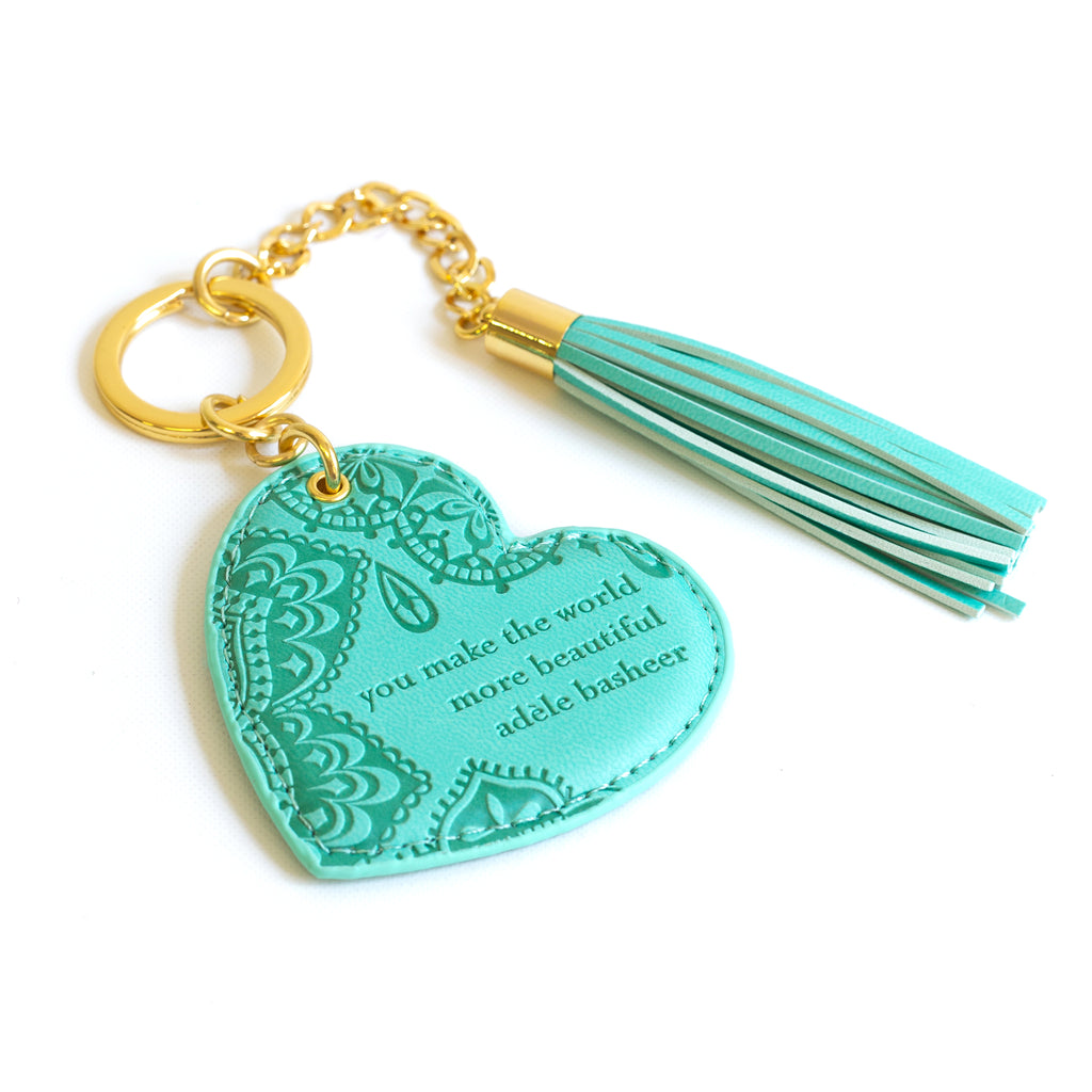 Inspirational vegan leather heart shaped turquoise aqua keychain with gold chain and aqua blue tassel. Designed in South Australia. Motivational quote by Adèle Basheer.