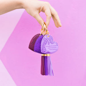 Perfect small gift for friends and family. Bright coloured Pantone colour of the year lilac heart shaped key holder with vegan leather floral pattern and lilac purple tassel. Featuring heartfelt quote by Adèle Basheer.