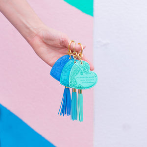 Bright coloured turquoise blue key holder with vegan leather floral pattern and aqua tassel. Featuring heartfelt quote by Adèle Basheer.