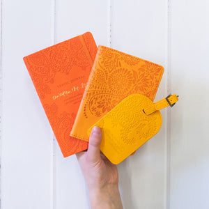 Intrinsic Luxe Faux Leather Travel Accessories with Inspirational Quotes- Bright orange Travel Journal, soft pastel orange passport wallet, yellow luggage tag 